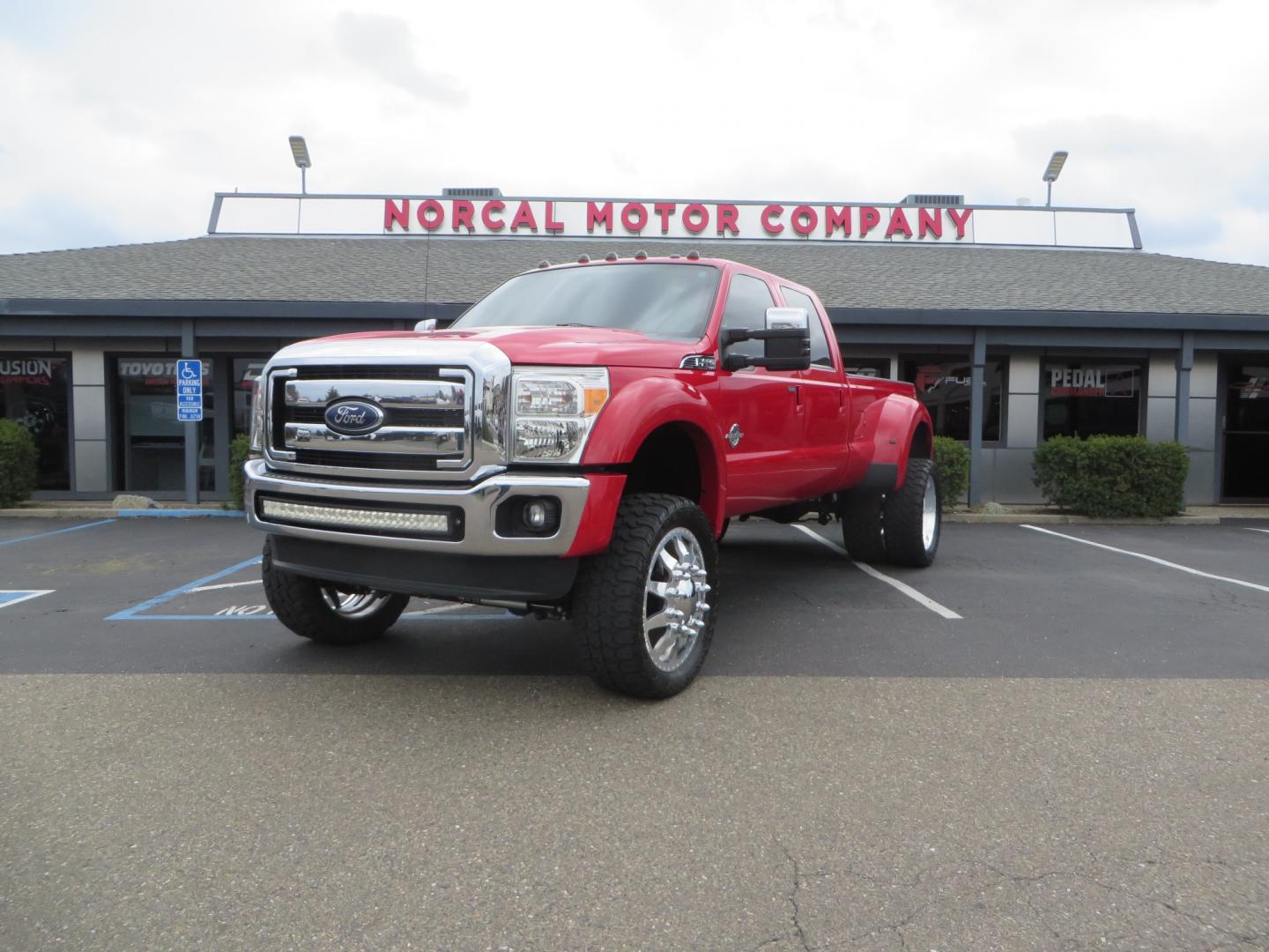 2014 Red /TAN Ford F450 Super Duty Crew Cab Lariat Crew Cab 4WD (1FT8W4DT7EE) with an V8 Turbo Diesel 6.7 Liter engine, Automatic 6-Spd w/SelectShift transmission, located at 2630 Grass Valley Highway, Auburn, CA, 95603, (530) 508-5100, 38.937893, -121.095482 - Wow!! 14 F450 sitting on Icon Vehicle Dynamics suspension, 24" American Force wheels, 37" tires, Rough Country back up leds, Light bar, Window tint, Smoked tail lights 3rd brake light, cab lights, and marker lights, Air bags with compressor, and train horns. Must see this head turner! - Photo#0